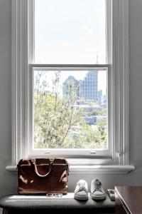 
a suitcase sitting on a window sill next to a window at Hotel Challis Potts Point in Sydney
