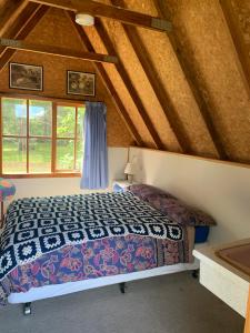 a bedroom with a bed in a attic at Strahan Backpackers in Strahan