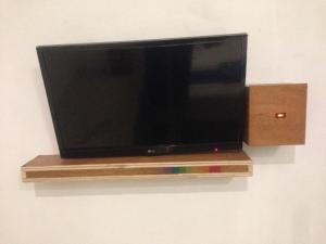 a flat screen tv hanging on a wall at Anyar in Mataram