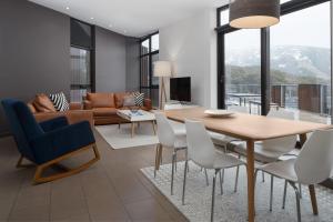 a living room with a table and chairs and a couch at St Falls Resort in Falls Creek