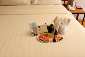 Ένα ή περισσότερα κρεβάτια σε δωμάτιο στο BATIQA Hotel Lampung