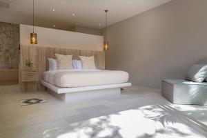 a bedroom with a large white bed in a room at Cielo Boutique Hotel & Spa Samui in Bophut 