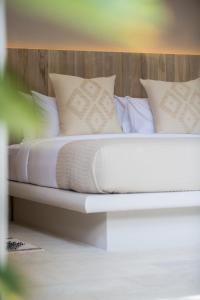 a bed with white sheets and pillows in a room at Cielo Boutique Hotel & Spa Samui in Bophut 
