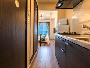 a kitchen with a sink and a counter top at Yukurina Resort Okinawa in Motobu