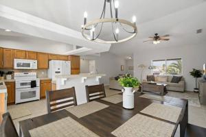 a kitchen and living room with a table and chairs at Playpool Oasis-Pool, Spa, Garage, Great Lake Views in Lake Havasu City