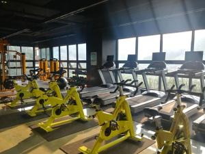 a gym with rows of exercise bikes and treadmills at Ocean View in Geoje 