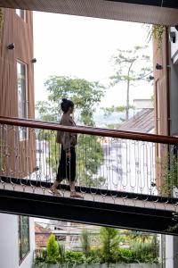 a person walking on a balcony of a building at Lasol Boutique Hotel in Da Lat