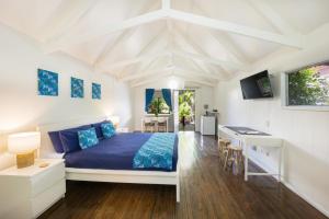 a bedroom with a bed and a desk in it at Airlie Beach Magnums - Adults Only in Airlie Beach
