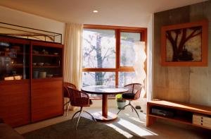 a living room with a table and chairs and a window at Sango Katase Guest Rooms in Fujisawa