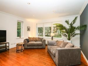 a living room with two couches and a tv at Boat House in Aberdeen