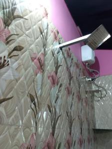 a shower curtain with a blow dryer on top of it at Agonda pink house in Canacona