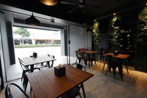 a restaurant with tables and chairs and a patio at The 192 Inn in Ji'an