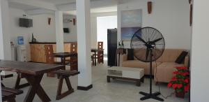 a living room with a table and a fan at Ahangama Eco Villa in Ahangama