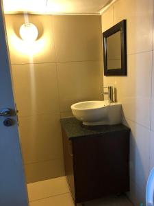 a bathroom with a sink and a mirror at Broadway flats Braamfontain in Johannesburg