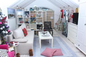 a living room with a christmas tree and a white couch at Art apartman in Kakanj
