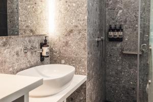 a bathroom with a sink, toilet and bathtub at Page148, Page Hotels in Hong Kong