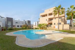 a swimming pool in front of a building at Penthouse La Cala De Mijas in La Cala de Mijas