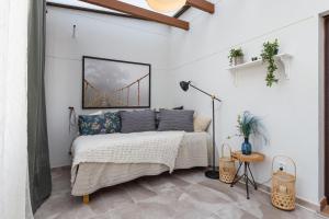 a white bedroom with a bed and a bridge at Penthouse La Cala De Mijas in La Cala de Mijas