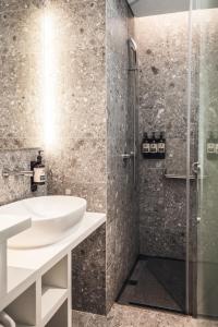 a bathroom with a sink and a shower at Page148, Page Hotels in Hong Kong