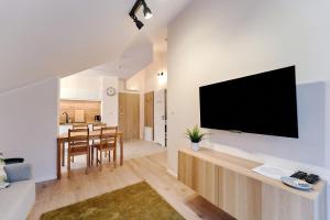 a living room with a flat screen tv on a wall at LAGUNA Apartament Polanica Residence 54 in Polanica-Zdrój