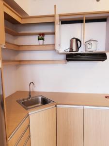 a kitchen with a sink and a microwave at Steff's Condo 1805 at Centrio Tower in Cagayan de Oro