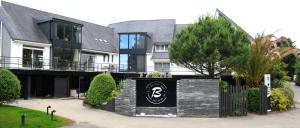 a house with a sign in front of it at Logis Golfe Hotel in Vannes