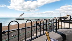 a bird flying over a beach and the ocean at Drakes Hotel in Brighton & Hove
