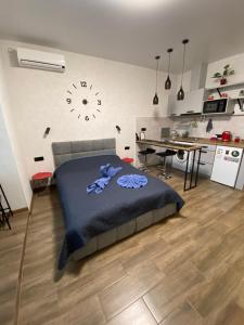 a bedroom with a bed and a desk and a clock at Lightroom in Kharkiv