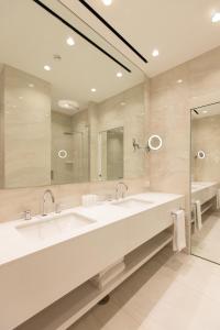 a bathroom with two sinks and a large mirror at Hotel Morfeo in Milan