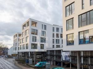 an apartment building on a city street at Limehome Mönchengladbach Fliethstraße in Mönchengladbach