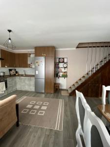 a kitchen and living room with a refrigerator and stairs at Смарт-квартира in Skole