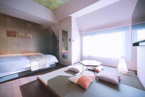 a bedroom with a bed and a large window at Asakusa Kaede 浅草楓 in Tokyo