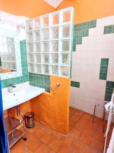 a bathroom with a sink and a mirror at Villa d'une chambre avec piscine privee jacuzzi et jardin amenage a Saint Georges de Luzencon in Saint-Georges-de-Luzençon