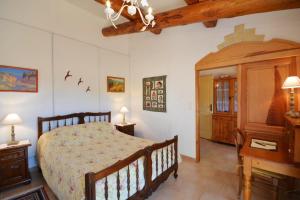 a bedroom with a large bed and a wooden cabinet at Maison de caractère à Ceyreste - Terrasse et jardin clôturé in Ceyreste