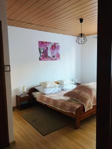 a bedroom with a bed with a wooden ceiling at Pokoje do wynajęcia Magdalena Nowak in Krynica Zdrój