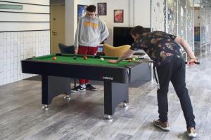 two men playing a game of pool with a table at For Students Only Private Bedrooms with Shared Kitchen at Riverside Way in Winchester in Winchester