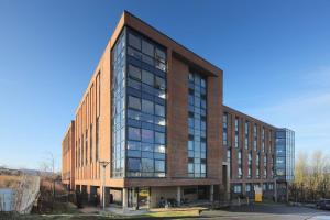 a large brick building with windows on a street at For Students Only Private Bedrooms with Shared Kitchen at Riverside Way in Winchester in Winchester