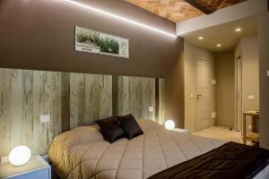 a bedroom with a bed with two pillows on it at La Crota Ristorante e Camere da Danilo dal 1983 in Roddi