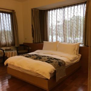 Postel nebo postele na pokoji v ubytování Qiao Kela Ti Homestay