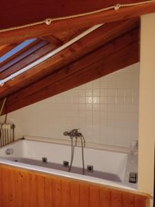 uma banheira com torneira na casa de banho em NAMOR - Atico Zen em Ribadeo