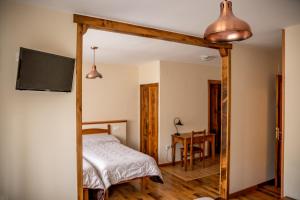 a bedroom with a bed and a television and a table at Hostal Restaurante Ventasierra in Valdoré