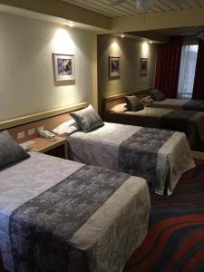 Tempat tidur dalam kamar di Hotel Fleming