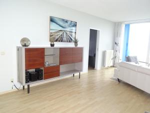 uma sala de estar com um sofá e uma cómoda em Kustverhuur, Appartement aan Zee, Prachtig appartement op de begane grond PS 13-001 em Breskens
