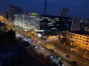 a city at night with traffic on a street at Take Timisoara Apartment in Timişoara