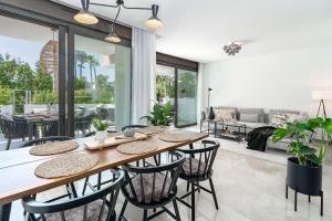 a dining room with a table and chairs at GG- Modern townhouse, families & couples only in Marbella