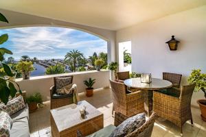 an outdoor patio with a table and chairs and a window at MA - Elegant Apartment with Sea views in Marbella