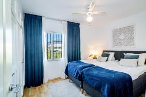 a bedroom with two beds and a window at MA - Elegant Apartment with Sea views in Marbella
