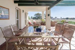 una mesa de cristal y sillas en un patio en LCR4- Large 3 bed apt close to beaches, en Marbella