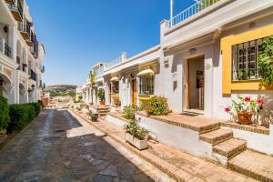 a cobblestone street in front of a building at AP165 - Contemporary Scandinavian Style Apartment in Marbella