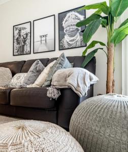 a living room with a brown couch and a plant at DN11-2 bedroom apartment close to Puerto Banus in Marbella +47 photos